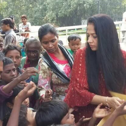 Shubhkarman volunteers with children and families at a distribution drive