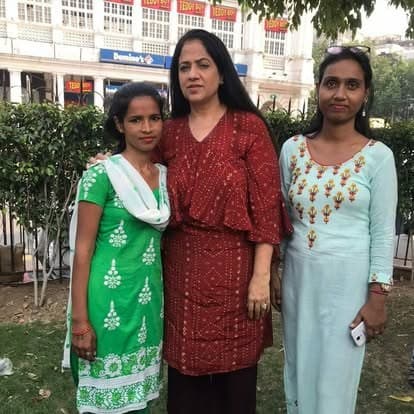 Shubhkarman volunteers with children and families at a distribution drive